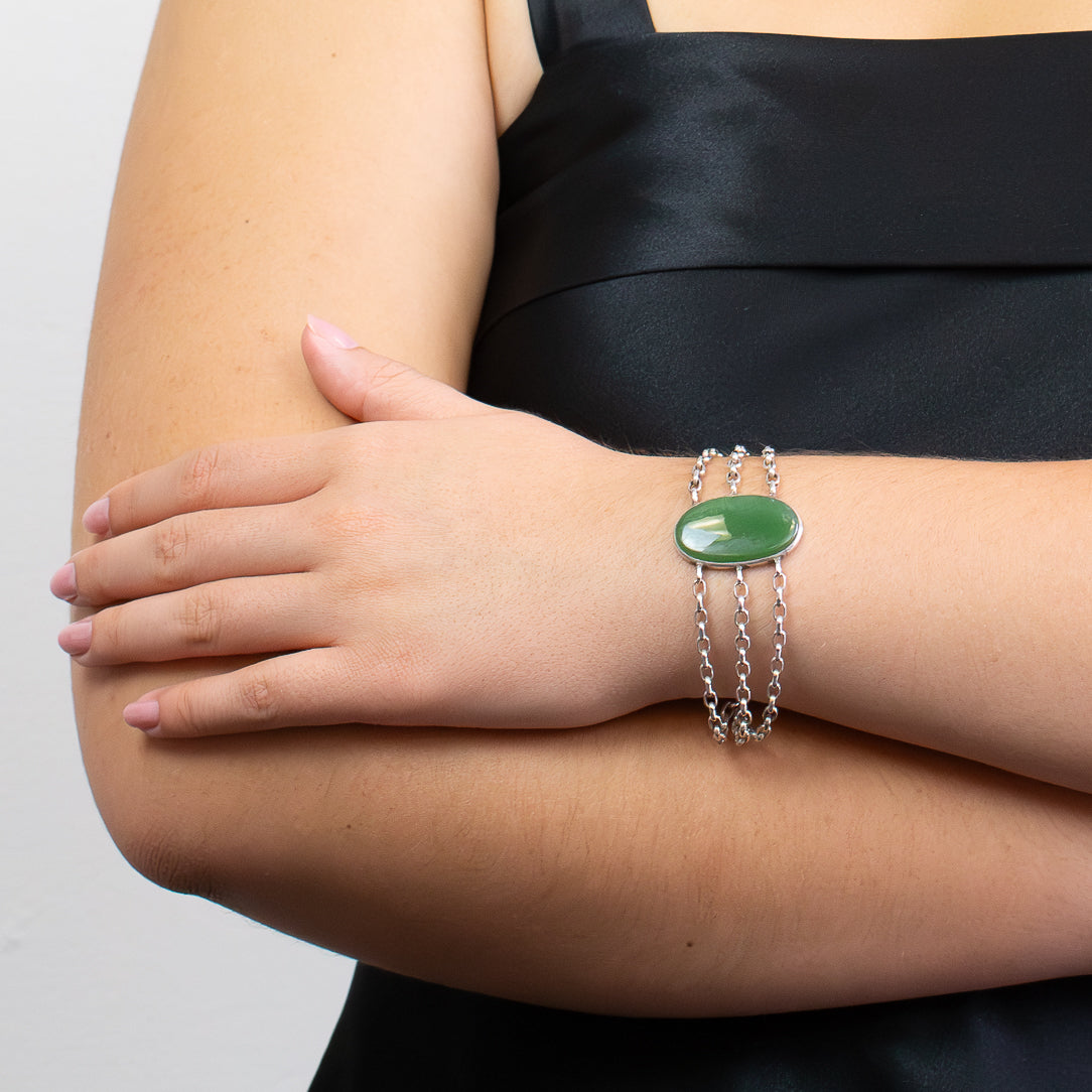 Nephrite Jade bracelet in sterling silver with polished green oval cabochon.