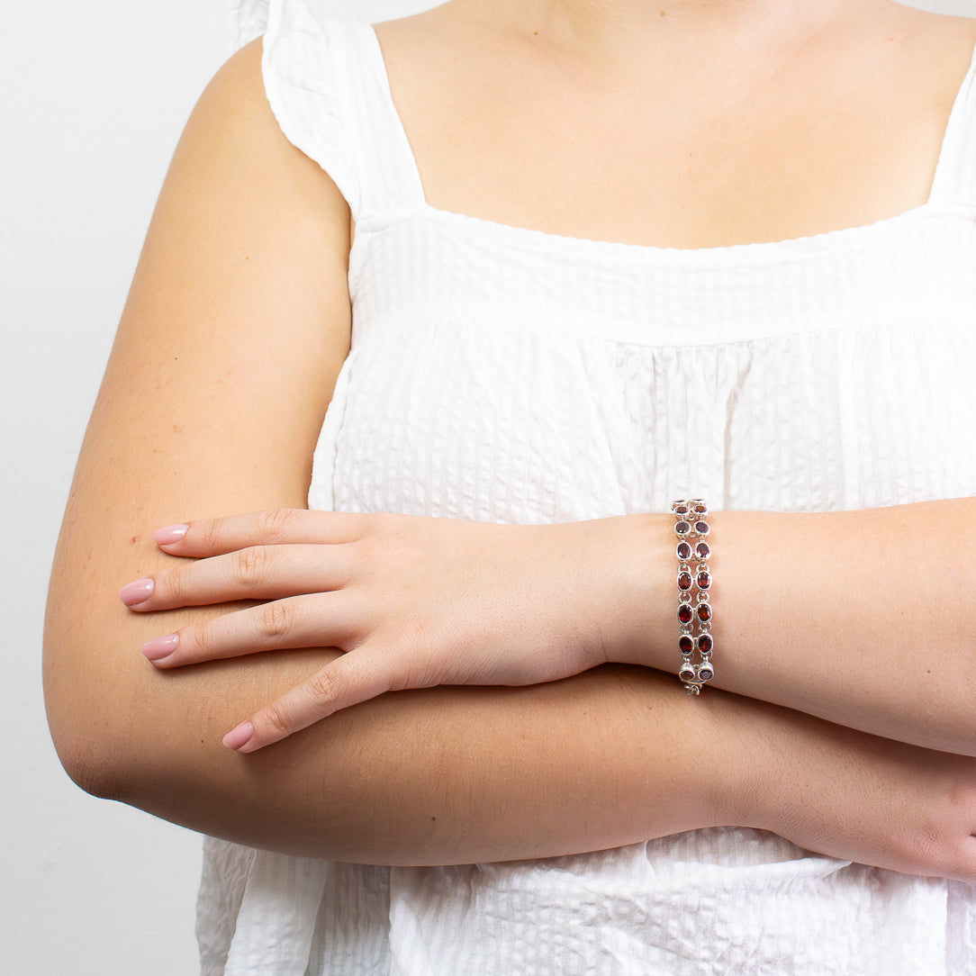 Faceted Garnet gemstone bracelet in sterling silver with deep red oval stones.