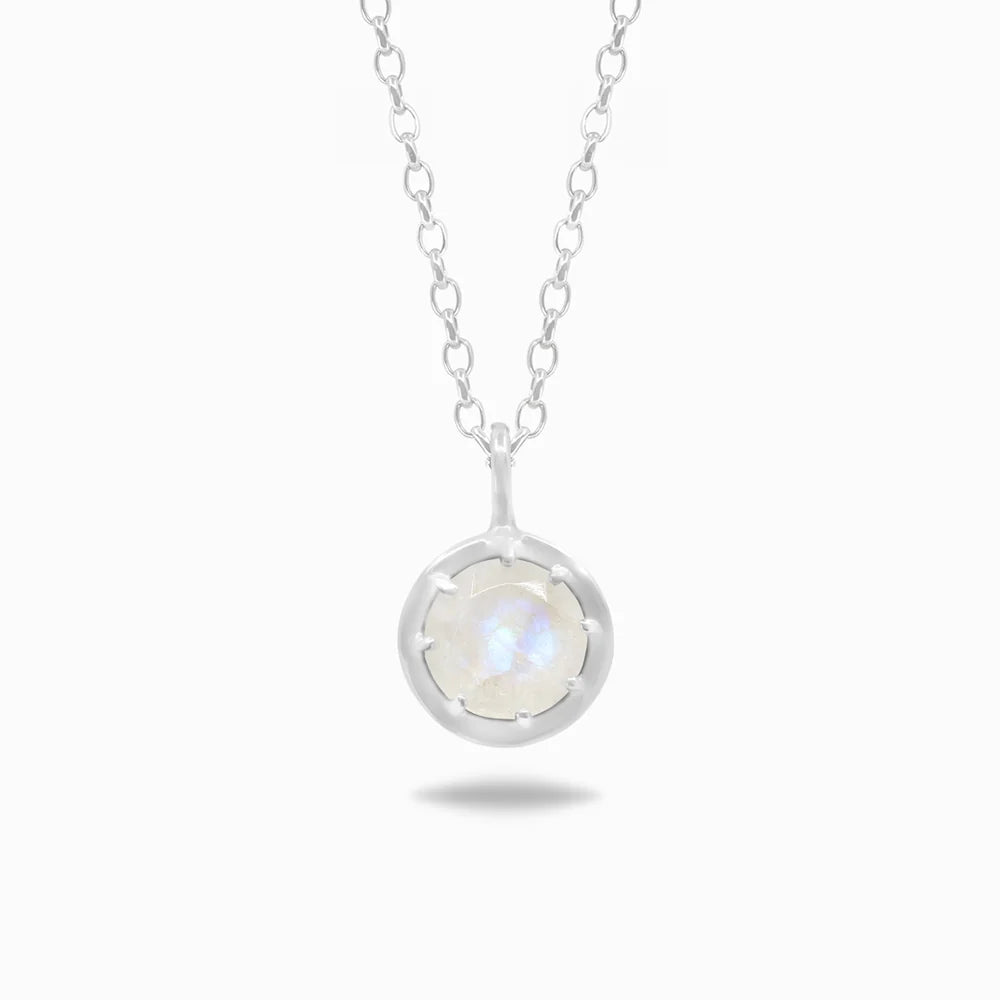 Round faceted Rainbow Moonstone with soft blue flash set in polished sterling silver pendant necklace.