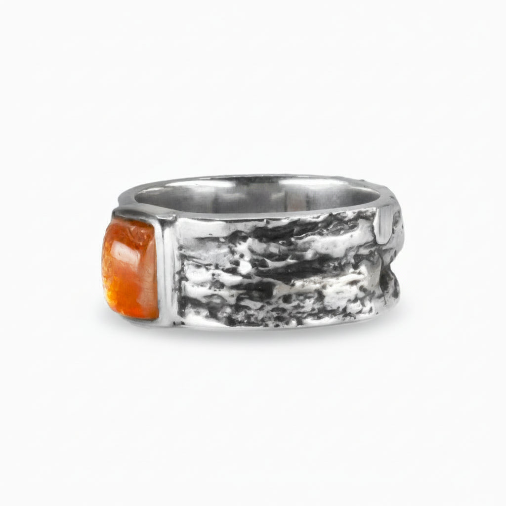 Rectangular Sunstone cabochon ring in textured sterling silver with glowing orange gemstone. MADE IN EARTH