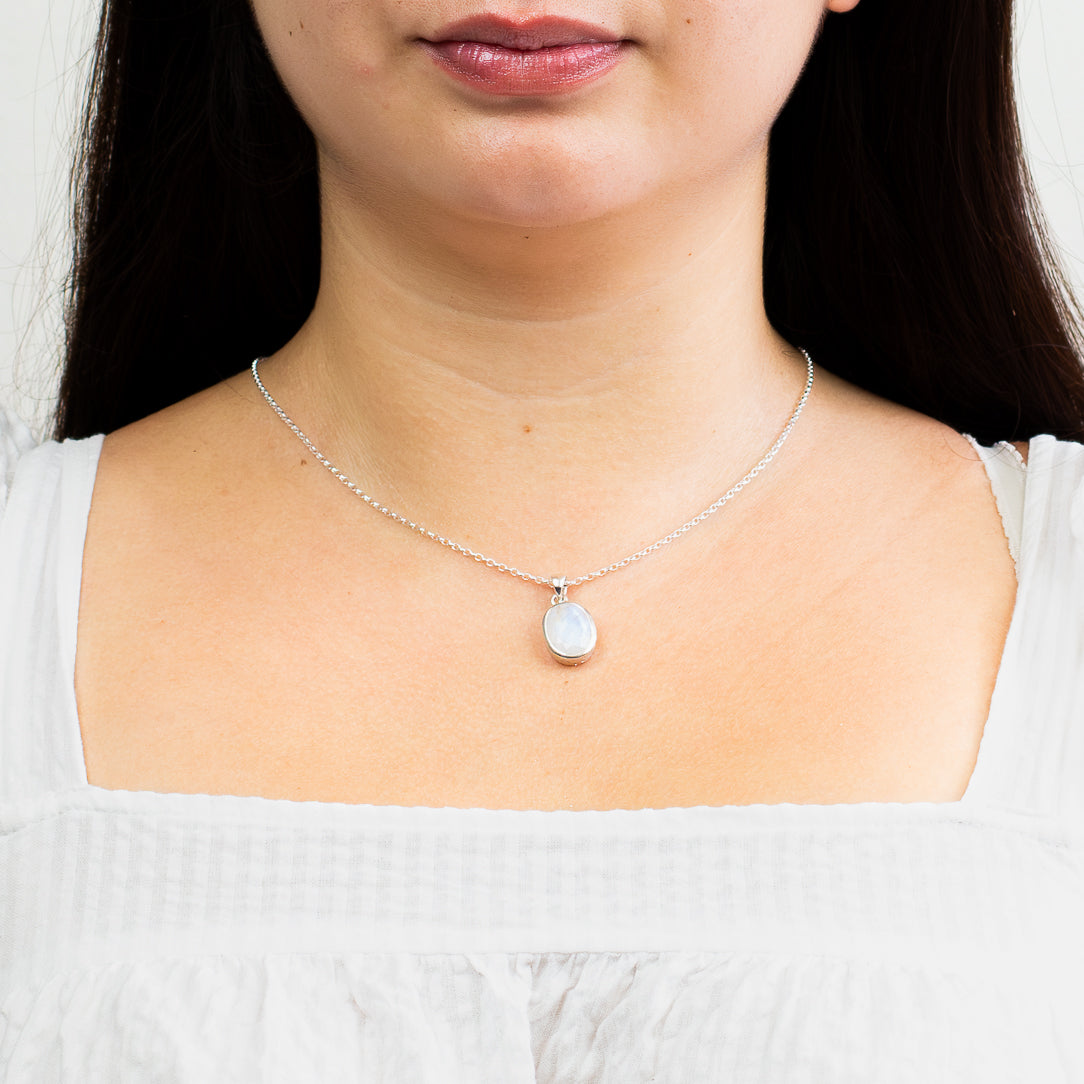 faceted rainbow moonstone necklace in sterling silver bezel  on model