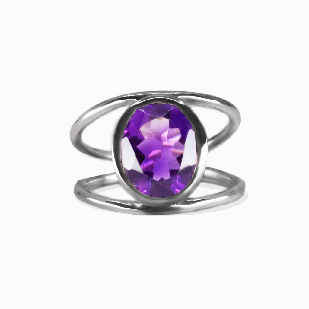 Faceted oval amethyst ring set in sterling silver with purple quartz gemstone. MADE IN EARTH