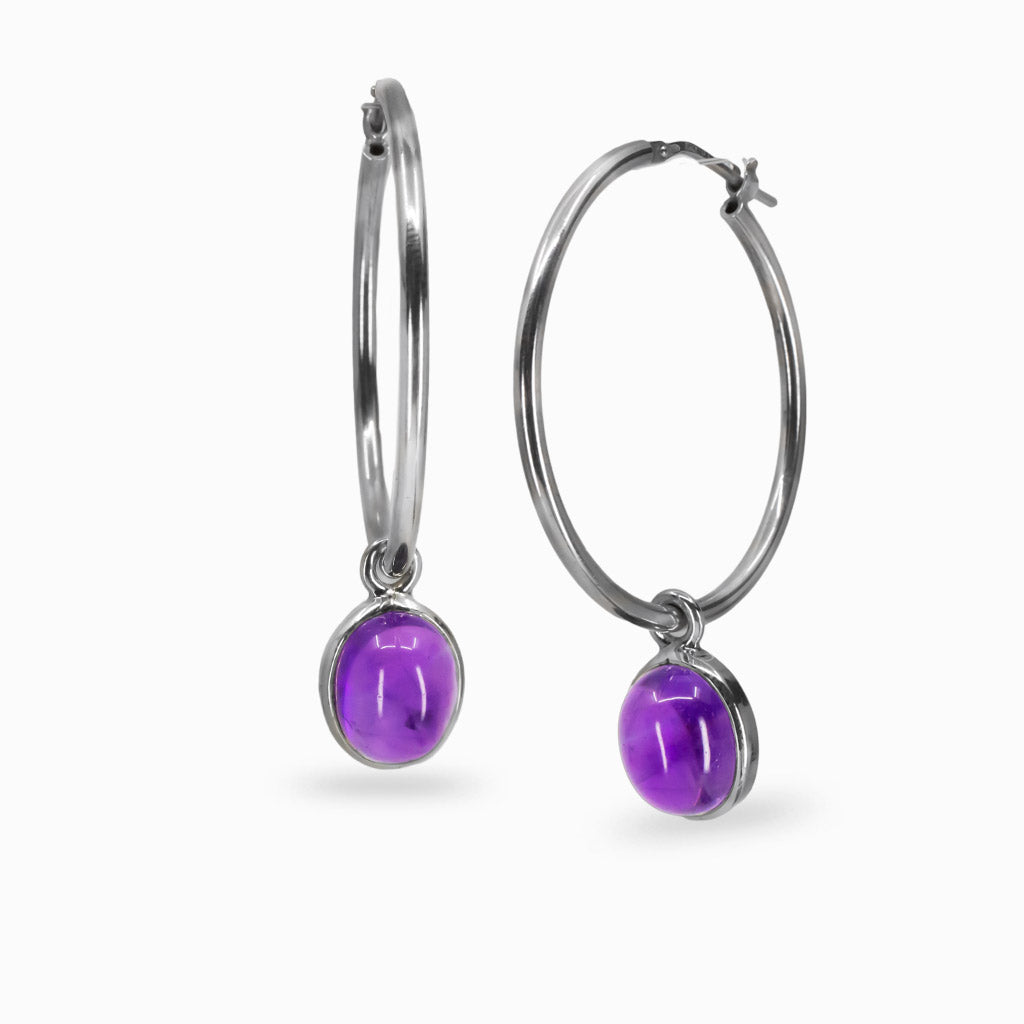 Oval amethyst cabochon hoop charms in sterling silver bezel attached to hoop earrings
