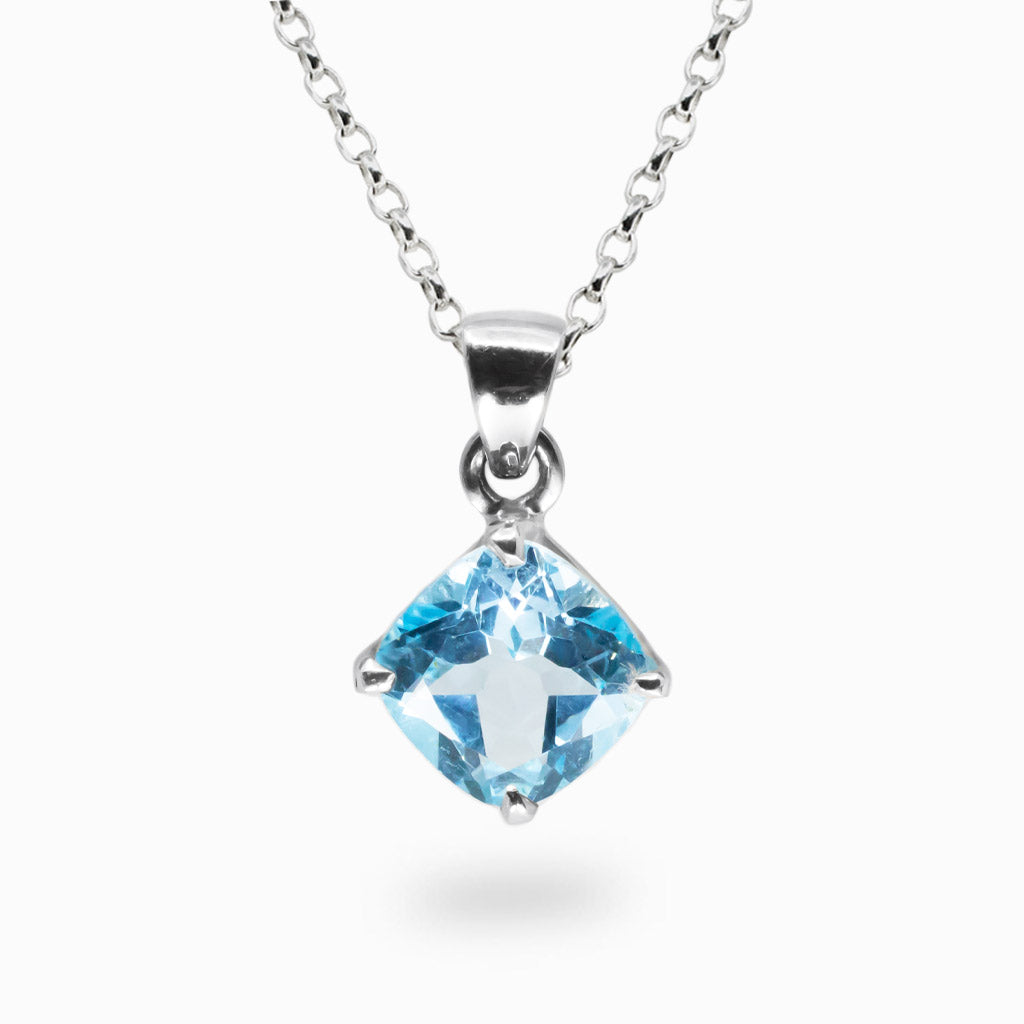 Faceted blue topaz pendant in a sterling silver claw setting on a chain. | MADE IN EARTH 