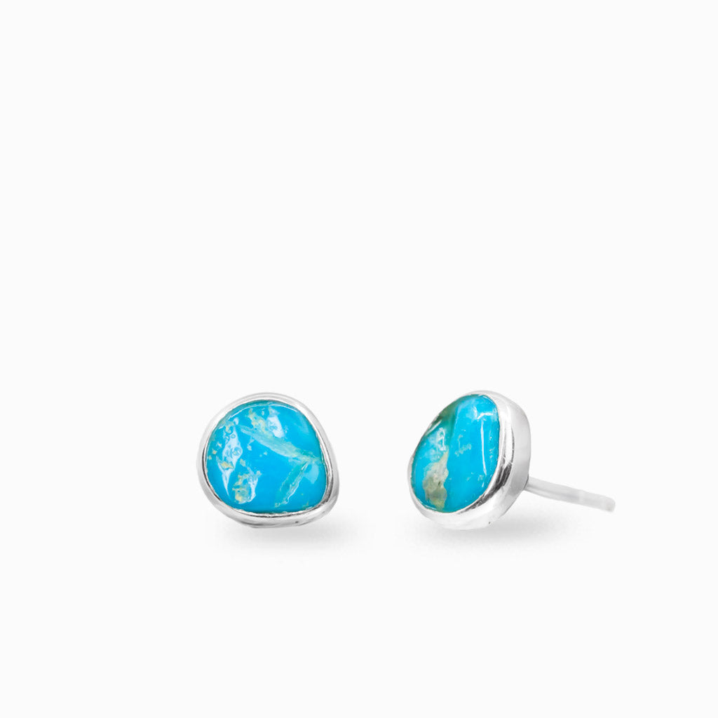 Raw Turquoise stud earrings in sterling silver featuring vibrant blue natural gemstone and organic matrix patterns.