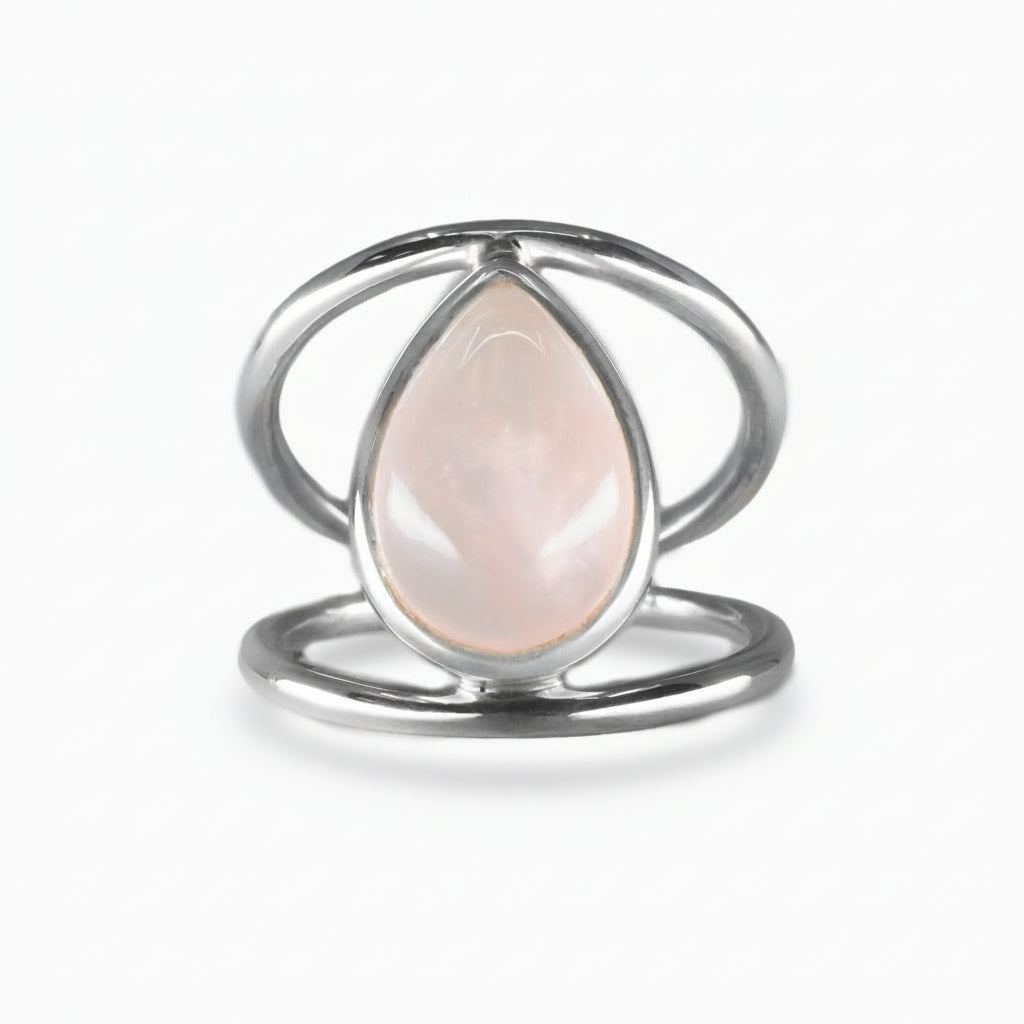 Teardrop Rose Quartz cabochon ring set in an open sterling silver band, featuring soft pink tones and a smooth, polished surface | MADE IN EARTH USA