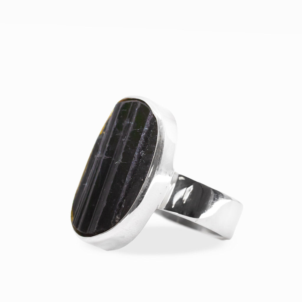 Large oval Black Tourmaline ring with natural vertical striations, polished sterling silver bezel setting, and wide band.