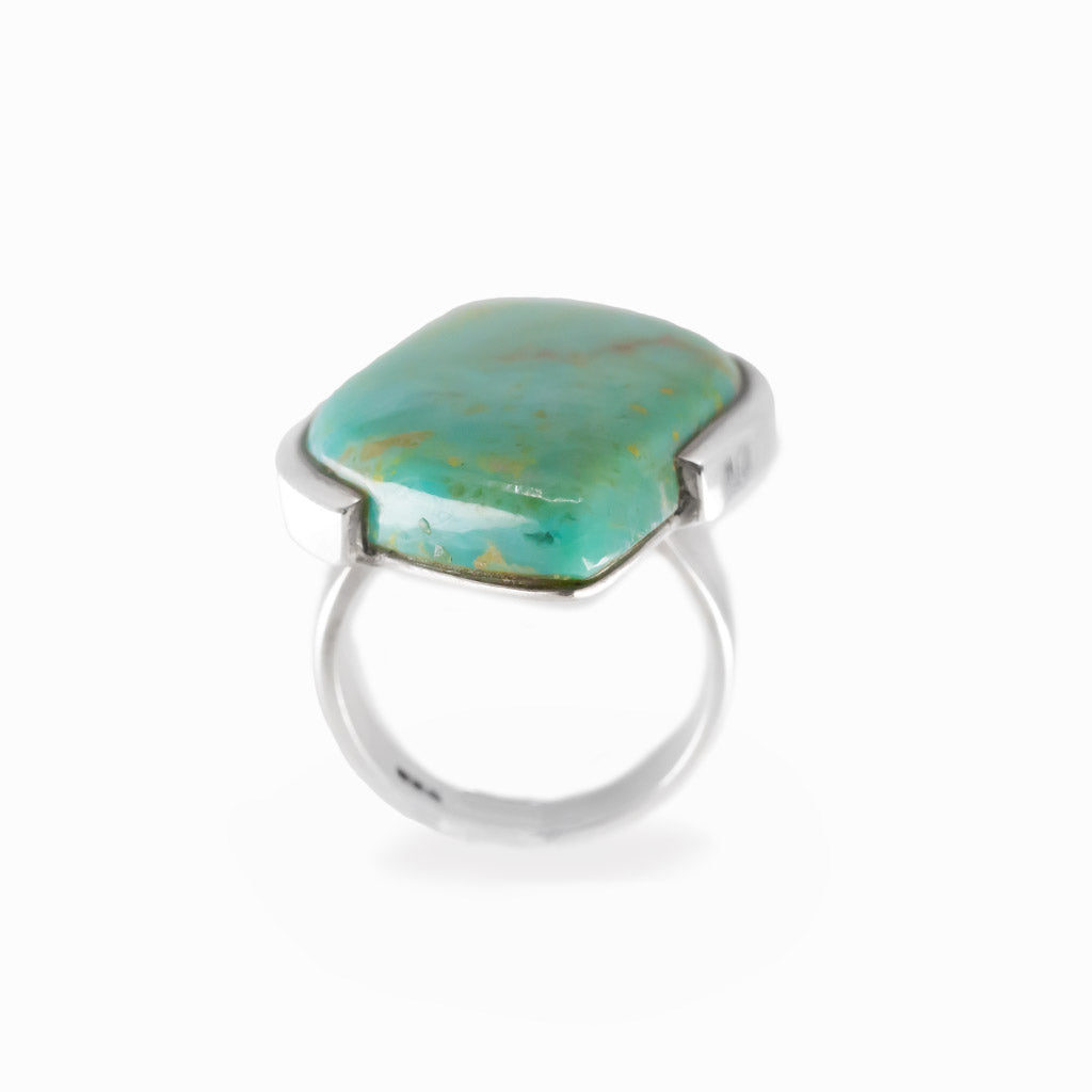 Campo Frio Turquoise freeform cabochon ring in polished sterling silver with aqua blue coloring and natural golden-brown matrix.