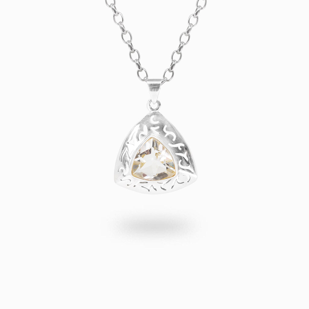 Faceted triangular Clear Quartz gemstone pendant surrounded by decorative openwork detailing in polished 925 sterling silver.