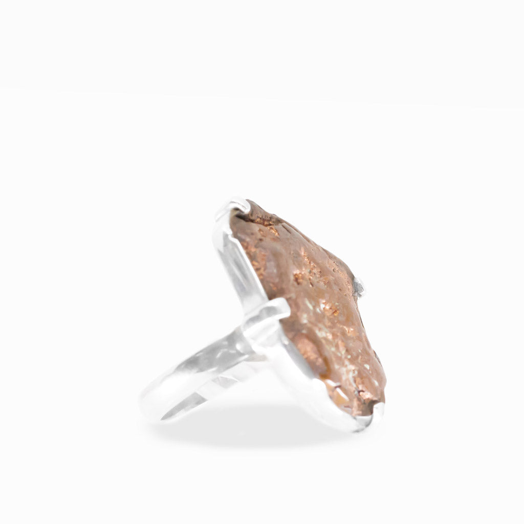 Freeform native Copper ring with warm rose-gold metallic tones, natural rough texture, and polished sterling silver prong setting.