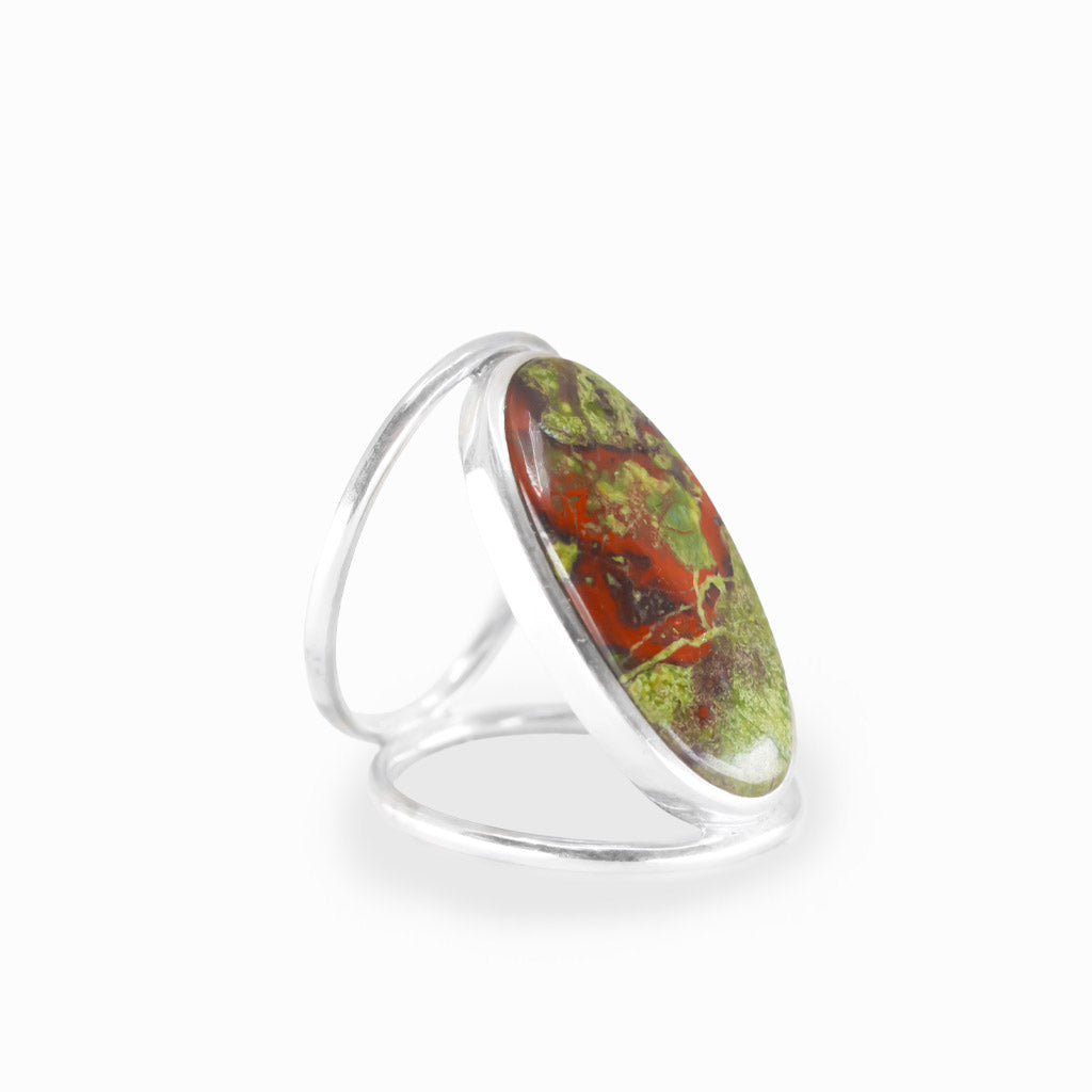 Oval Dragon's Blood Jasper ring with forest-green and crimson-red natural patterns, polished sterling silver bezel, and openwork band.