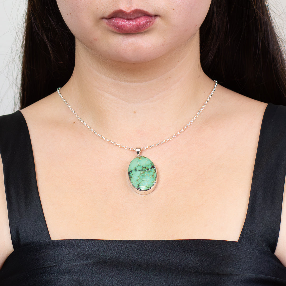 CABOCHON OVAL TIBERTAN TURQUOISE BEZEL PENDANT STERLING SILVER ON MODEL | MADE IN EARTH