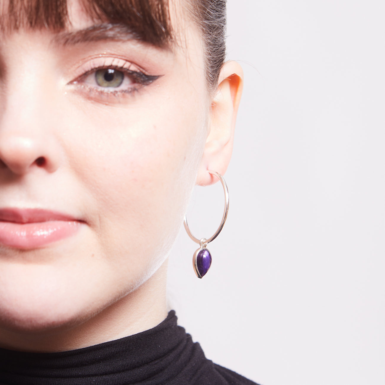 INVERTED CABOCHON AMETHYST CHARMS ON EARRINGS ON MODEL