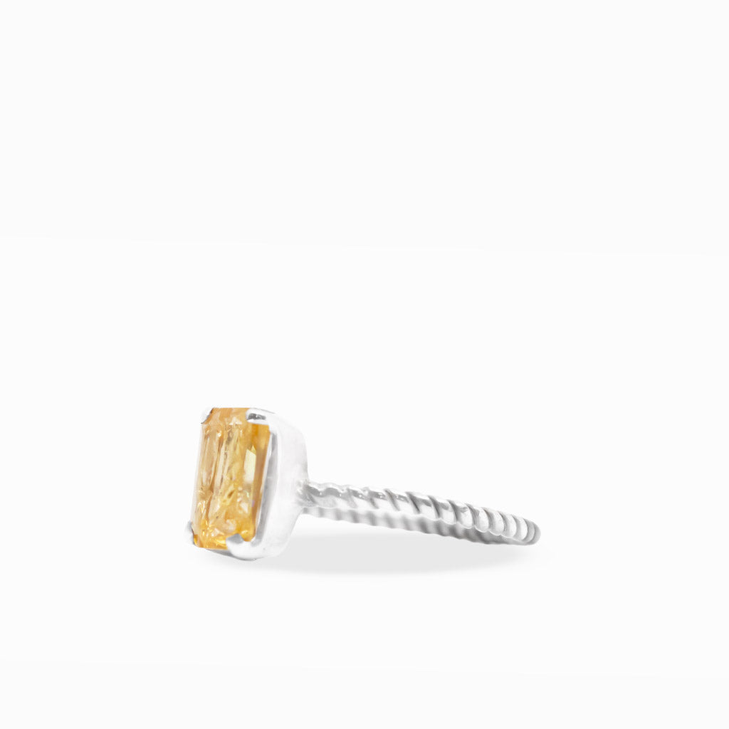 Golden-orange emerald-cut Imperial Topaz ring with sterling silver prong setting and delicate twisted rope-style band.