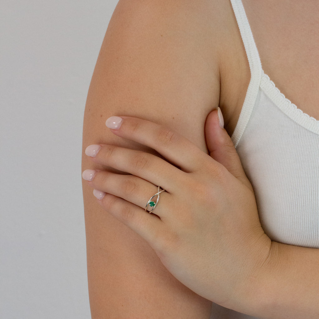 faceted round Birthstone Emerald ring on model