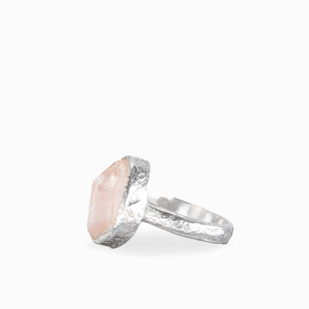 Freeform Rose Quartz ring with pale blush-pink gemstone, natural striations, textured sterling silver bezel, and matching band.