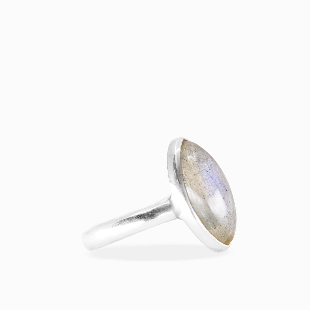 Marquise Labradorite ring with translucent gray gemstone, delicate blue flashes, natural inclusions, and polished sterling silver bezel setting.