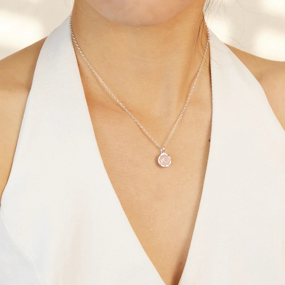 Round faceted pink Rose Quartz gemstone set in polished sterling silver pendant necklace.