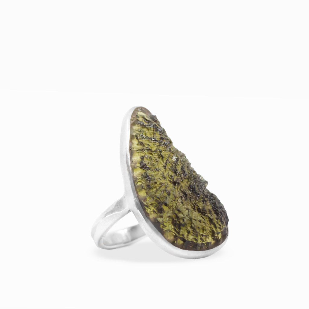 Freeform olive-green Moldavite ring with translucent textured tektite surface, polished sterling silver bezel setting, and smooth band.
