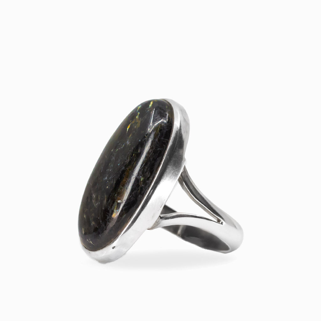 Elongated oval Nuummite cabochon ring with dark tones and subtle golden flashes in polished 925 sterling silver.