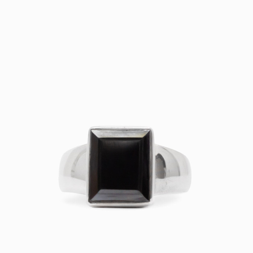Dark metallic rectangular faceted Hematite gemstone set vertically in a polished 925 sterling silver ring.