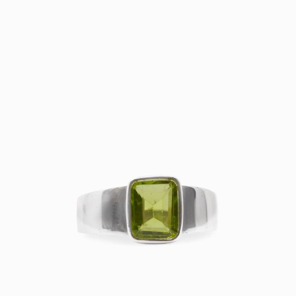 Vibrant green rectangular faceted Peridot gemstone bezel set in a polished 925 sterling silver ring.