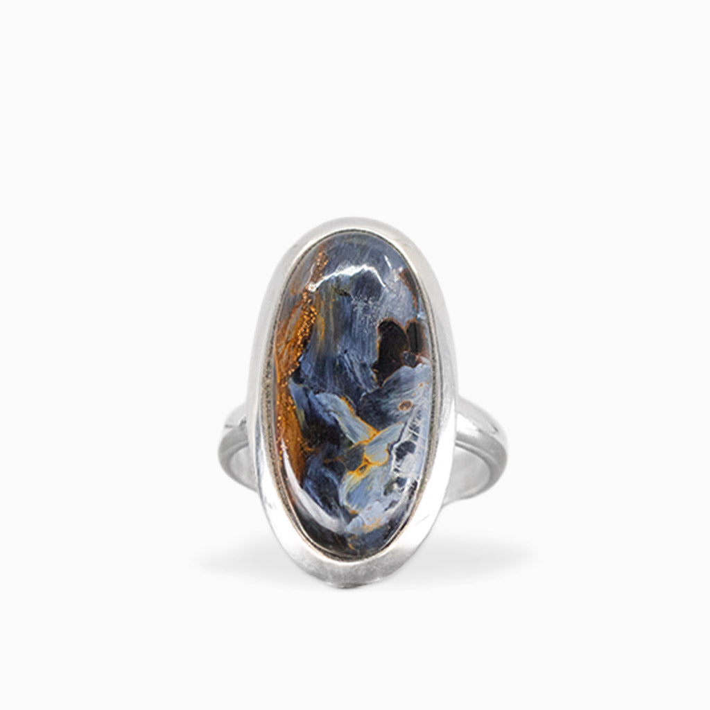 Elongated oval Pietersite ring with swirling midnight-blue, charcoal, and golden-brown patterns in polished sterling silver.