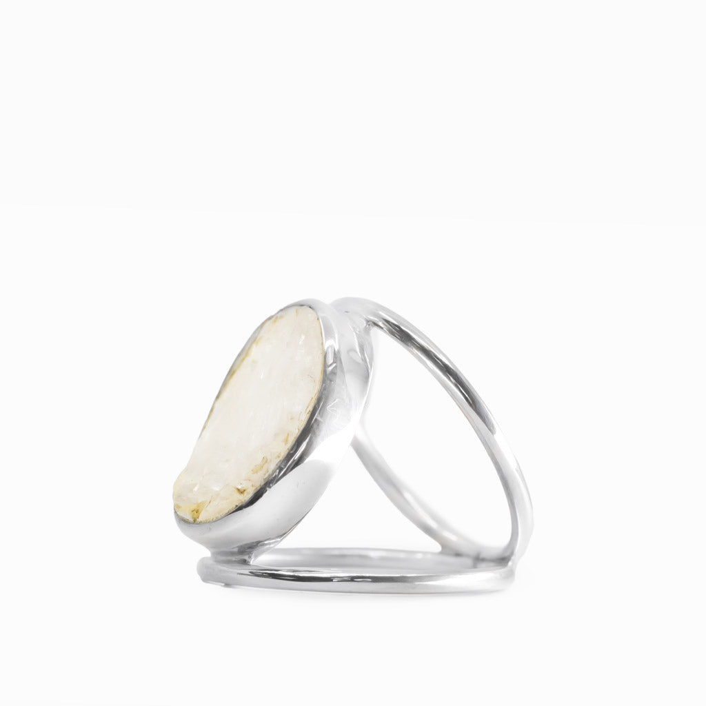 Oval Rainbow Moonstone ring with milky-white gemstone, subtle natural inclusions, polished sterling silver bezel, and openwork band.