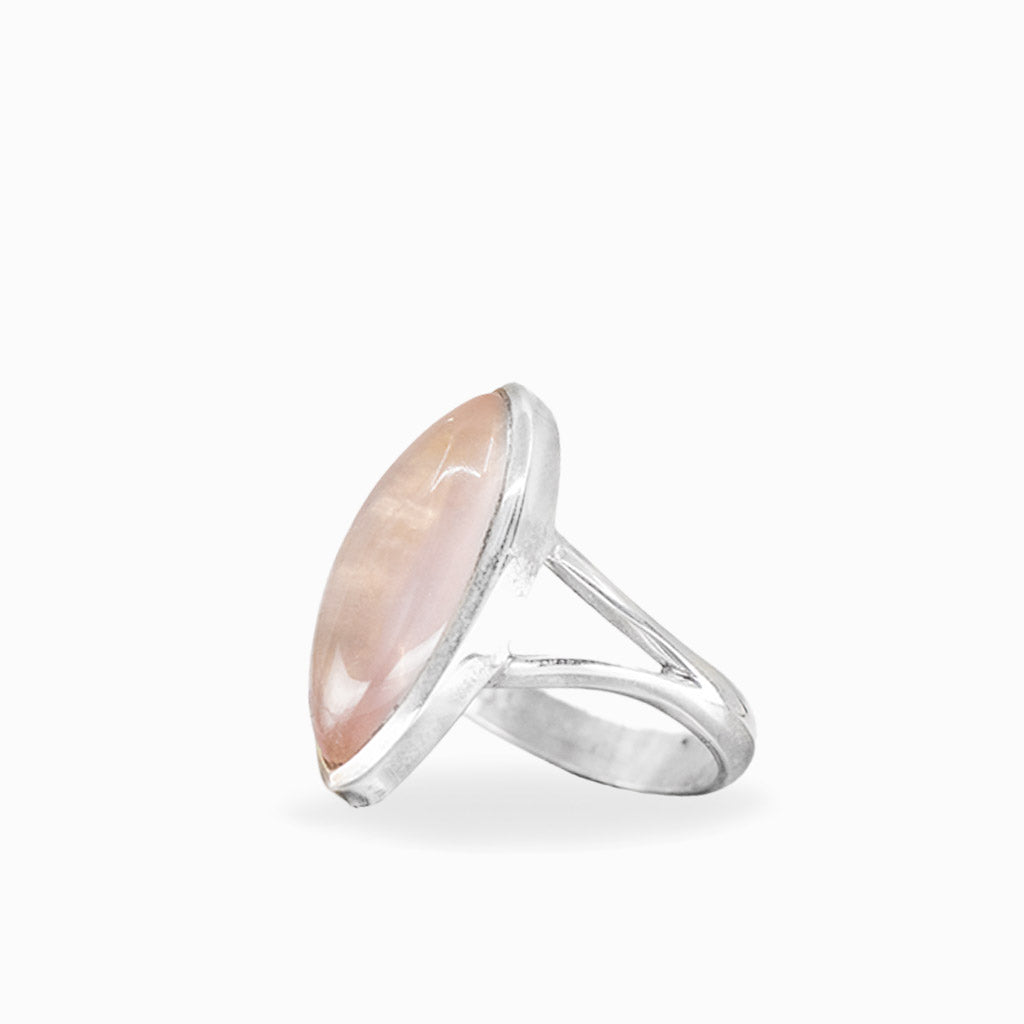 Marquise Rose Quartz ring with soft blush-pink cabochon, polished sterling silver bezel setting, and elegant split band.