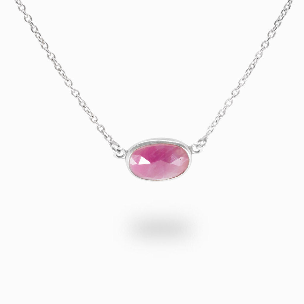 Faceted oval Ruby necklace in sterling silver bezel setting.