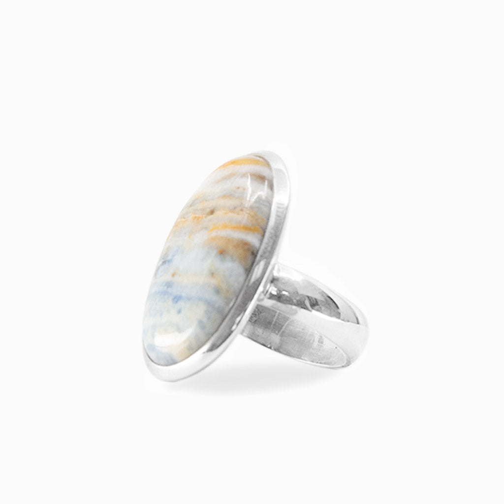 Oval Scheelite cabochon with natural cream, blue and golden banding set in 925 sterling silver.