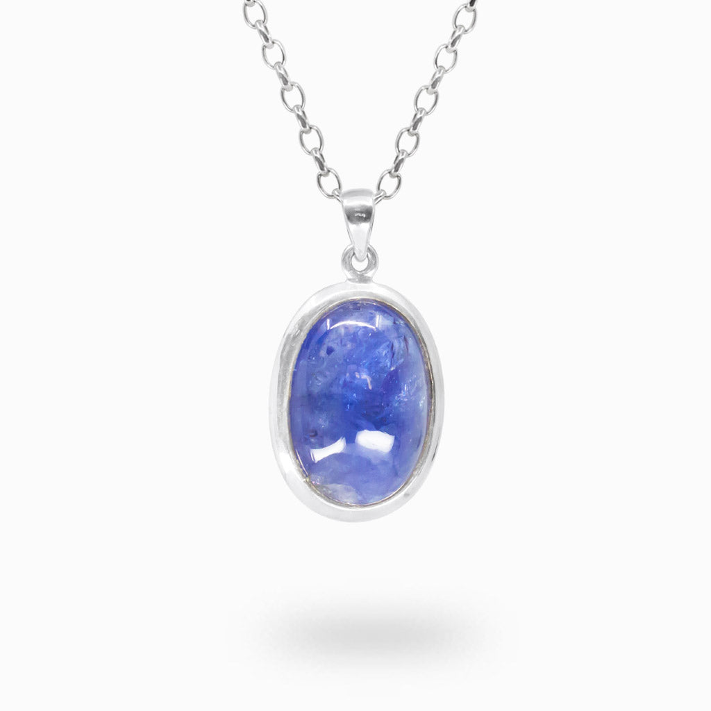 Oval violet-blue Tanzanite cabochon pendant with natural internal variations in polished 925 sterling silver.