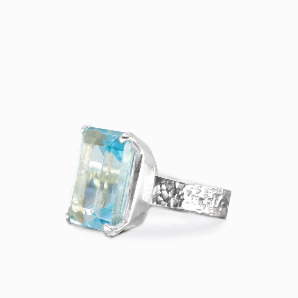 Faceted rectangular blue topaz ring in sterling silver