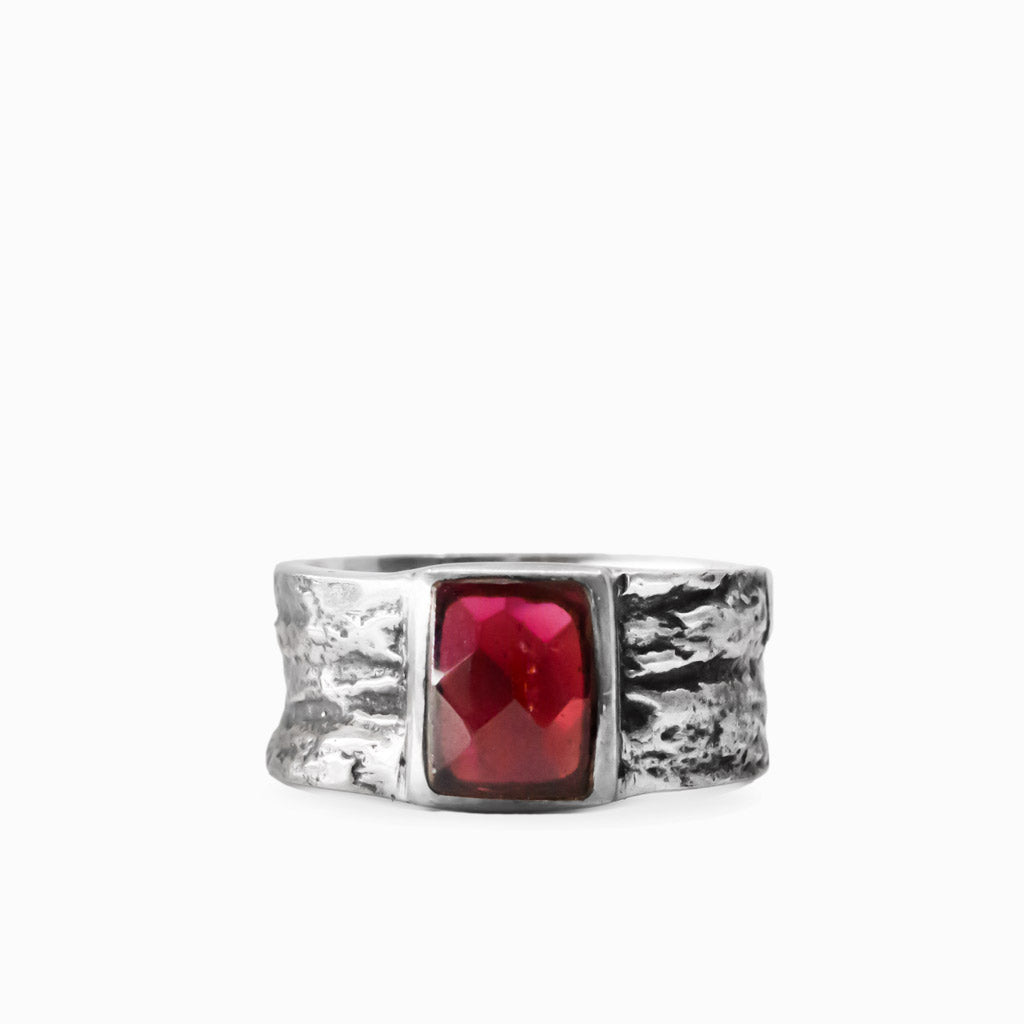 Rectangular faceted red Garnet gemstone set in a wide textured 925 sterling silver ring.