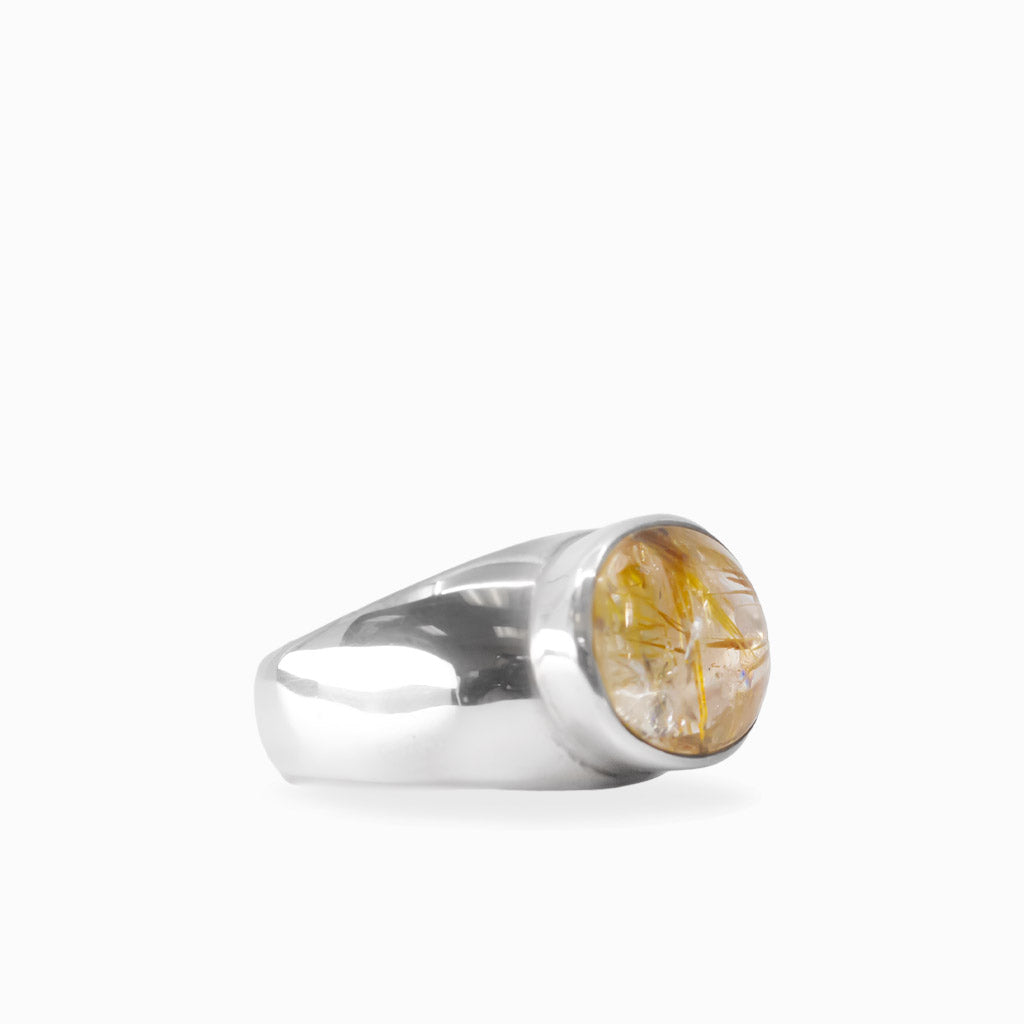 Oval Golden Rutilated Quartz cabochon with prominent golden needles bezel set in 925 sterling silver.