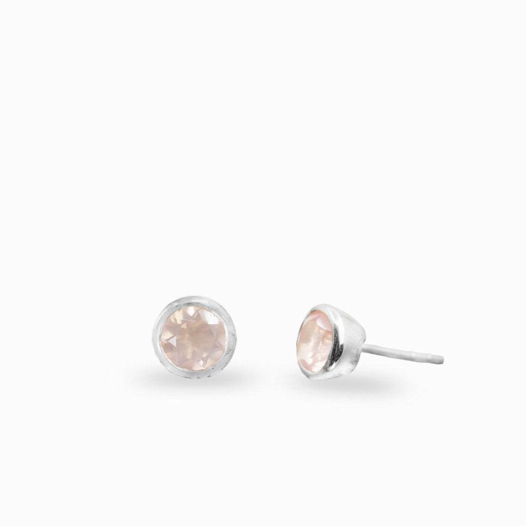 Sterling silver round stud earrings featuring faceted Rose Quartz gemstones.