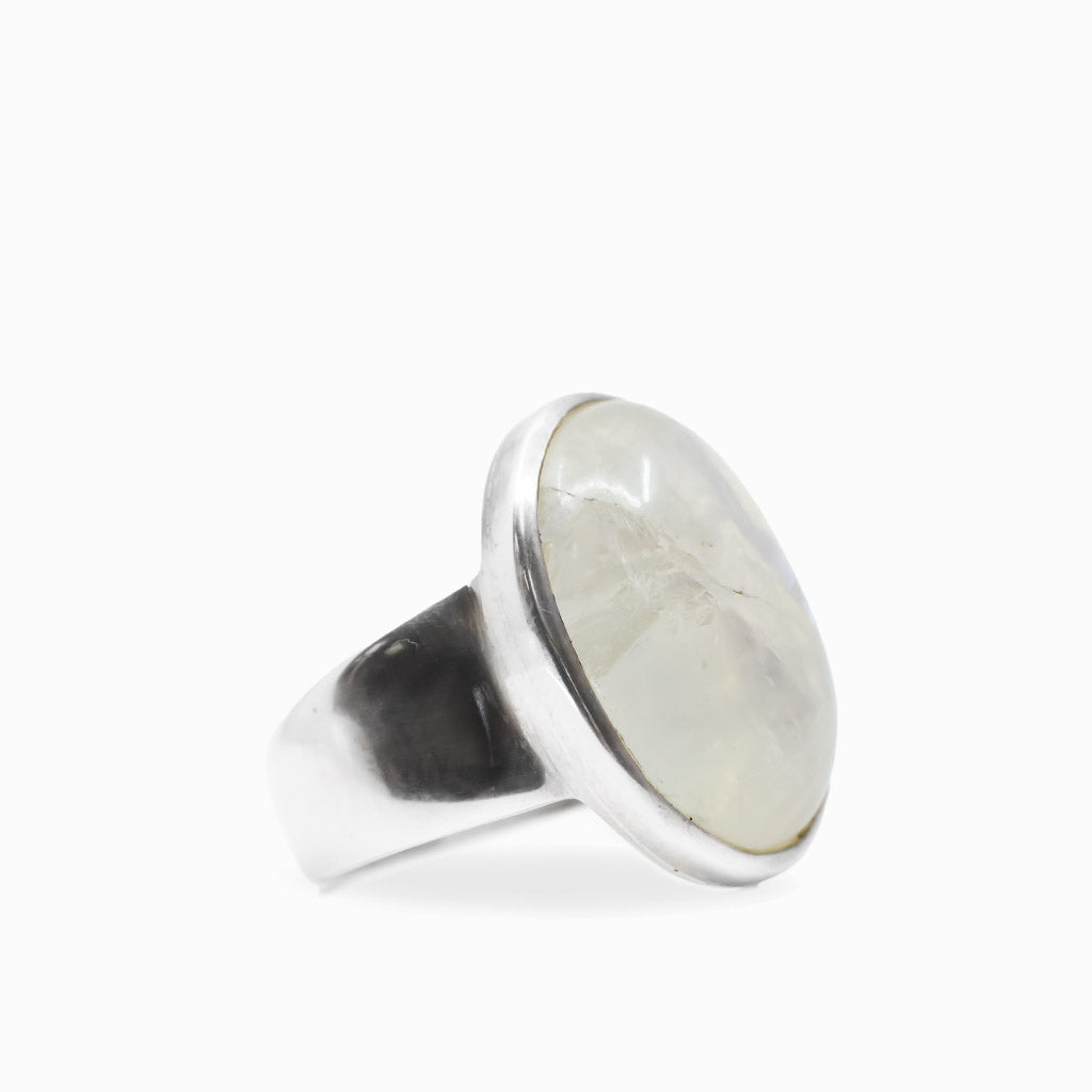 Oval Rainbow Moonstone cabochon ring with luminous white iridescence set in polished 925 sterling silver.