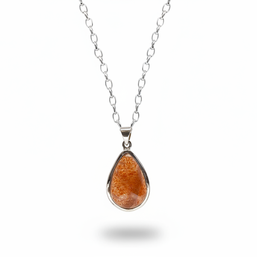 Teardrop sunstone cabochon pendant with warm orange sparkle in sterling silver necklace