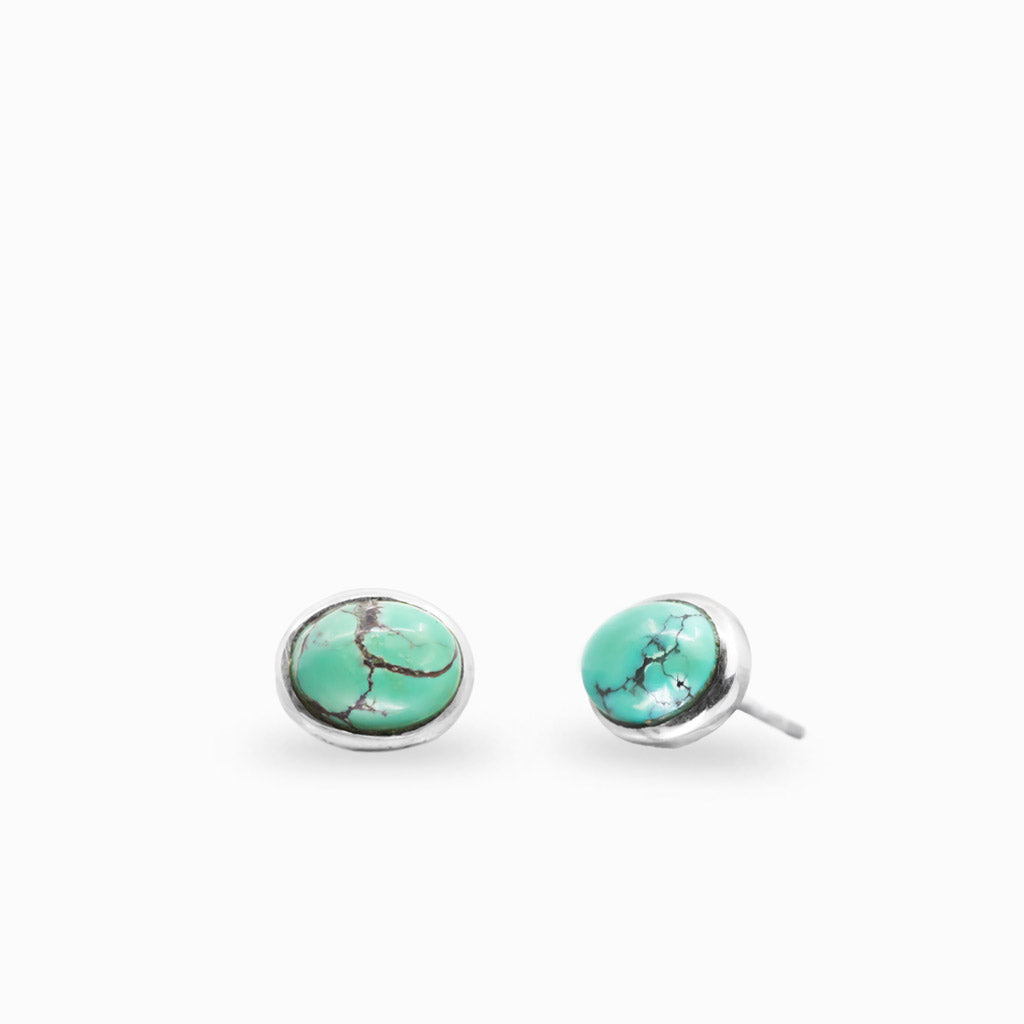 Sterling silver oval stud earrings featuring Tibetan Turquoise gemstones.